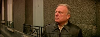 Movie still from “I Stand Alone” (1998), directed by Gaspar Noé – An older man wearing a leather jacket looking to his left; Close Up shot, High angle