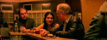 Movie still from “I Stand Alone” (1998), directed by Gaspar Noé – A man and a woman sitting at a table; Medium shot, Over the shoulder angle
