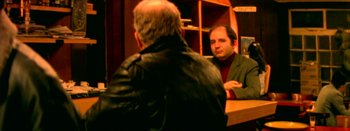Movie still from “I Stand Alone” (1998), directed by Gaspar Noé – A man in a leather jacket is looking at another man in a brown jacket; Medium shot, Over the shoulder angle