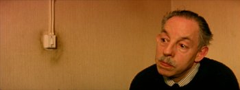 Movie still from “I Stand Alone” (1998), directed by Gaspar Noé – An older man with a mustache is looking at the camera; Close Up shot, Low angle