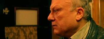 Movie still from “I Stand Alone” (1998), directed by Gaspar Noé – An older man with blue eyes stares into the distance; Close Up shot, Low angle