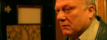 Movie still from “I Stand Alone” (1998), directed by Gaspar Noé – An older man with a serious look on his face; Close Up shot, Low angle