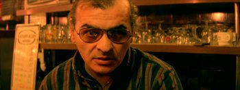 Movie still from “I Stand Alone” (1998), directed by Gaspar Noé – A person wearing glasses; Close Up shot, Low angle