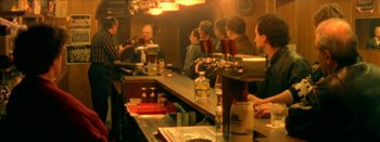 Movie still from “I Stand Alone” (1998), directed by Gaspar Noé – A group of people sitting at a bar drinking beer; Medium shot, Over the shoulder angle