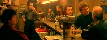 Movie still from “I Stand Alone” (1998), directed by Gaspar Noé – A group of people sitting at a bar; Medium shot, High angle