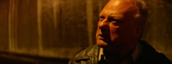 Movie still from “I Stand Alone” (1998), directed by Gaspar Noé – An older man wearing a leather jacket looking off into the distance; Close Up shot, Low angle