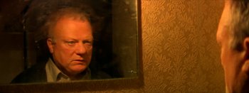 Movie still from “I Stand Alone” (1998), directed by Gaspar Noé – A man looking at himself in a mirror; Close Up shot, Over the shoulder angle