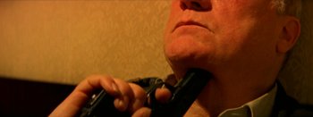 Movie still from “I Stand Alone” (1998), directed by Gaspar Noé – A man holding a pair of scissors in his mouth; Extreme Close Up shot, High angle