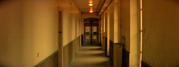 Movie still from “I Stand Alone” (1998), directed by Gaspar Noé – A long hallway with many doors in it; Wide shot, High angle