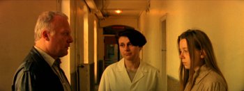 Movie still from “I Stand Alone” (1998), directed by Gaspar Noé – A man wearing a white lab coat and a black hat; Close Up shot, Low angle