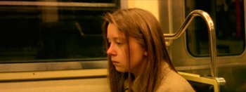Movie still from “I Stand Alone” (1998), directed by Gaspar Noé – A girl with long brown hair sitting on a train; Close Up shot, High angle