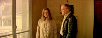 Movie still from “I Stand Alone” (1998), directed by Gaspar Noé – A man and a woman standing next to each other in a room; Medium shot, Low angle