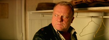 Movie still from “I Stand Alone” (1998), directed by Gaspar Noé – An older man wearing a black leather jacket looking at the camera; Close Up shot, Low angle