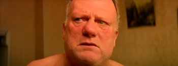 Movie still from “I Stand Alone” (1998), directed by Gaspar Noé – An older man with a frown on his face; Close Up shot, Low angle