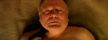 Movie still from “I Stand Alone” (1998), directed by Gaspar Noé – An older man is holding a cell phone in his hand; Extreme Close Up shot, Overhead angle