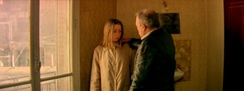 Movie still from “I Stand Alone” (1998), directed by Gaspar Noé – A man and a woman standing next to each other in front of a wall; Medium shot, Over the shoulder angle