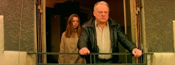 Movie still from “I Stand Alone” (1998), directed by Gaspar Noé – A man and a woman standing next to a railing; Medium shot, Low angle