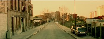 Movie still from “I Stand Alone” (1998), directed by Gaspar Noé – An image of a street that has a lot of trees on it; Extreme Wide shot, High angle