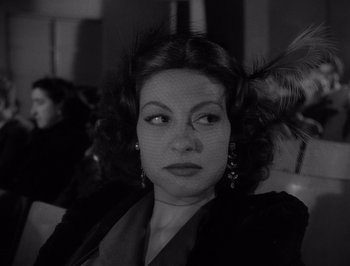 Movie still from “I Vitelloni” (1953), directed by Federico Fellini – A black and white photo of a woman with a veil on her head; Close Up shot, Over the shoulder angle