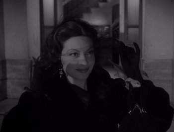 Movie still from “I Vitelloni” (1953), directed by Federico Fellini – A black and white photo of a woman in a black coat; Close Up shot, Over the shoulder angle