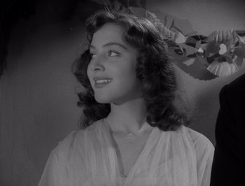 Movie still from “I Vitelloni” (1953), directed by Federico Fellini – A black - and - white photo of a woman with long hair; Close Up shot, Low angle