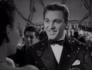 Movie still from “I Vitelloni” (1953), directed by Federico Fellini – A black and white photo of a man in a tuxedo; Close Up shot, Low angle