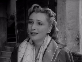 Movie still from “I Vitelloni” (1953), directed by Federico Fellini – An old photo of a woman with a scarf around her neck; Close Up shot, High angle