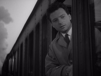 Movie still from “I Vitelloni” (1953), directed by Federico Fellini – A black and white photo of a man in a suit and tie; Close Up shot, Low angle