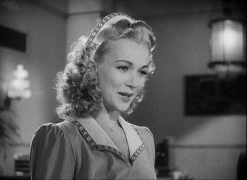 Movie still from “I Wake Up Screaming” (1941), directed by H. Bruce Humberstone – A black and white photo of a woman in a dress; Close Up shot, Over the shoulder angle