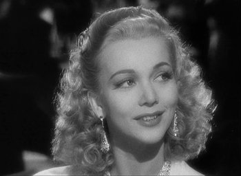 Movie still from “I Wake Up Screaming” (1941), directed by H. Bruce Humberstone – A black and white photo of a woman with long curly hair; Close Up shot, Over the shoulder angle