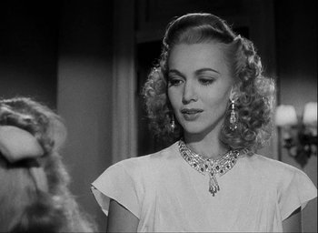 Movie still from “I Wake Up Screaming” (1941), directed by H. Bruce Humberstone – A black and white photo of a woman in a white dress; Close Up shot, Over the shoulder angle