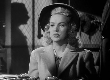 Movie still from “I Wake Up Screaming” (1941), directed by H. Bruce Humberstone – A black and white photo of a woman wearing a hat; Medium shot, Low angle