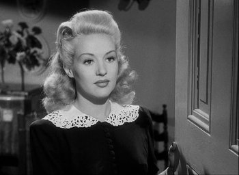 Movie still from “I Wake Up Screaming” (1941), directed by H. Bruce Humberstone – A black and white photo of a woman in a black dress; Close Up shot, Over the shoulder angle