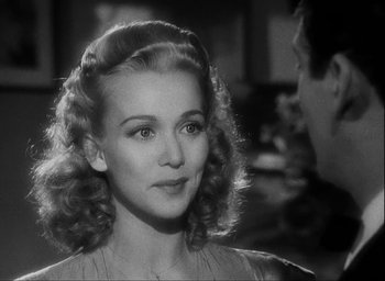 Movie still from “I Wake Up Screaming” (1941), directed by H. Bruce Humberstone – A black and white photo of a woman in a dress; Close Up shot, Over the shoulder angle