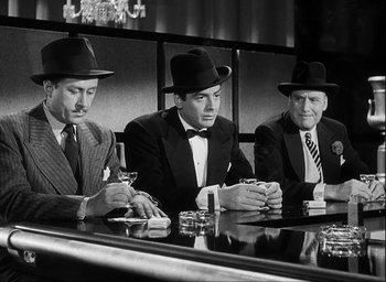 Movie still from “I Wake Up Screaming” (1941), directed by H. Bruce Humberstone – A group of men sitting at a table with drinks; Medium shot, Low angle