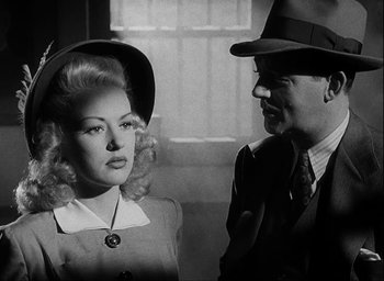 Movie still from “I Wake Up Screaming” (1941), directed by H. Bruce Humberstone – A man and a woman standing next to each other; Close Up shot, Low angle