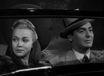 Movie still from “I Wake Up Screaming” (1941), directed by H. Bruce Humberstone – A man and a woman sitting in the back seat of a car; Close Up shot, Low angle