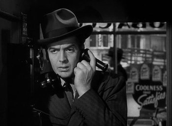 Movie still from “I Wake Up Screaming” (1941), directed by H. Bruce Humberstone – A black and white photo of a man talking on a phone; Close Up shot, Low angle
