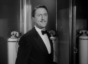 Movie still from “I Wake Up Screaming” (1941), directed by H. Bruce Humberstone – A black and white photo of a man in a tuxedo; Close Up shot, Low angle