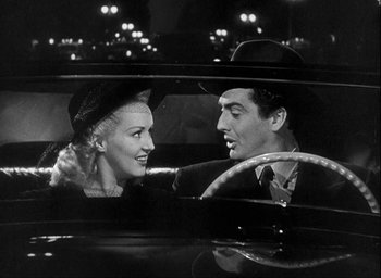 Movie still from “I Wake Up Screaming” (1941), directed by H. Bruce Humberstone – A man and a woman sitting in the back seat of a car; Medium shot, Low angle