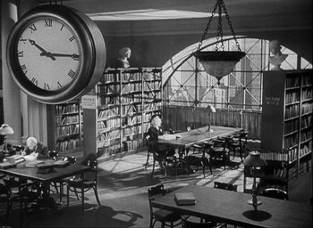 Movie still from “I Wake Up Screaming” (1941), directed by H. Bruce Humberstone – An old photo of a library with a clock hanging from the ceiling; Extreme Wide shot, High angle