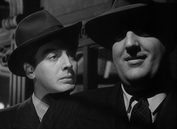 Movie still from “I Wake Up Screaming” (1941), directed by H. Bruce Humberstone – A black and white photo of two men wearing hats; Close Up shot, Low angle