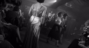 Movie still from “I Want to Live!” (1958), directed by Robert Wise – A group of people dancing in a room; Wide shot, Low angle