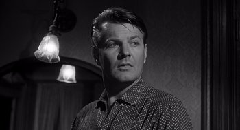 Movie still from “I Want to Live!” (1958), directed by Robert Wise – Black and white photograph of a man in a room; Close Up shot, Low angle