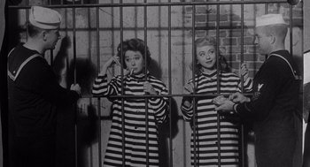 Movie still from “I Want to Live!” (1958), directed by Robert Wise – A couple of women standing next to each other; Medium shot, High angle