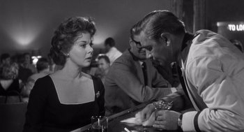 Movie still from “I Want to Live!” (1958), directed by Robert Wise – An old photo of a man and a woman at a bar; Medium shot, Over the shoulder angle