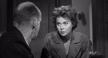 Movie still from “I Want to Live!” (1958), directed by Robert Wise – An old photo of a woman looking at a man in a suit in front of a mirror; Close Up shot, Over the shoulder angle