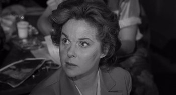 Movie still from “I Want to Live!” (1958), directed by Robert Wise – An older woman looking at the camera while sitting down; Close Up shot, High angle