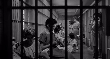 Movie still from “I Want to Live!” (1958), directed by Robert Wise – A black and white photo of a group of women sitting in a jail cell; Wide shot, High angle