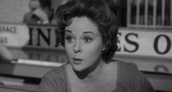 Movie still from “I Want to Live!” (1958), directed by Robert Wise – An old photo of an older woman looking at the camera; Close Up shot, Over the shoulder angle